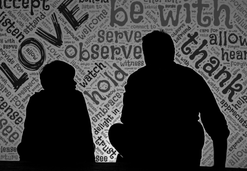 Image of the backs of a man and boy talking. Image credit: Johnhain via pixabay.com