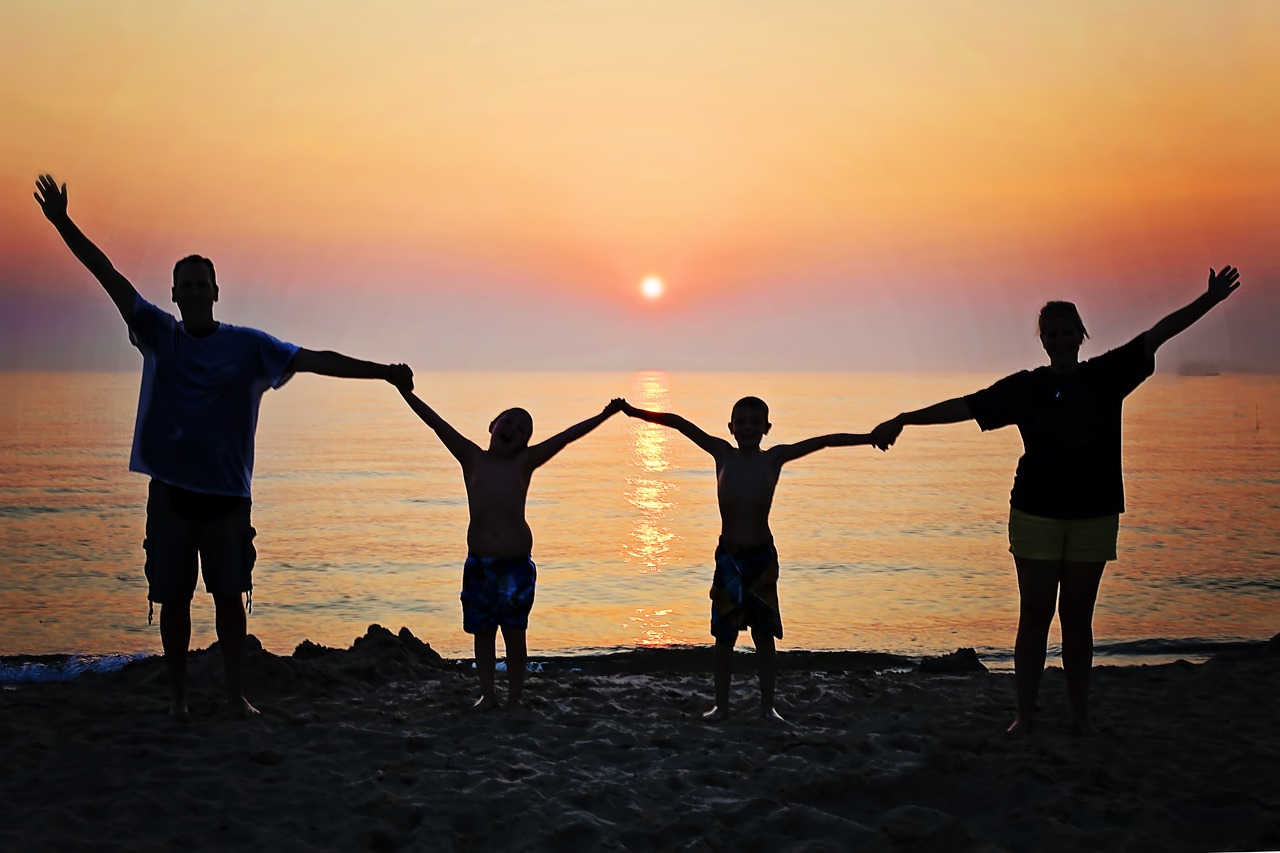 Image of people standing with their arms wide open, looking at the sky.Image credit: Pixby.com